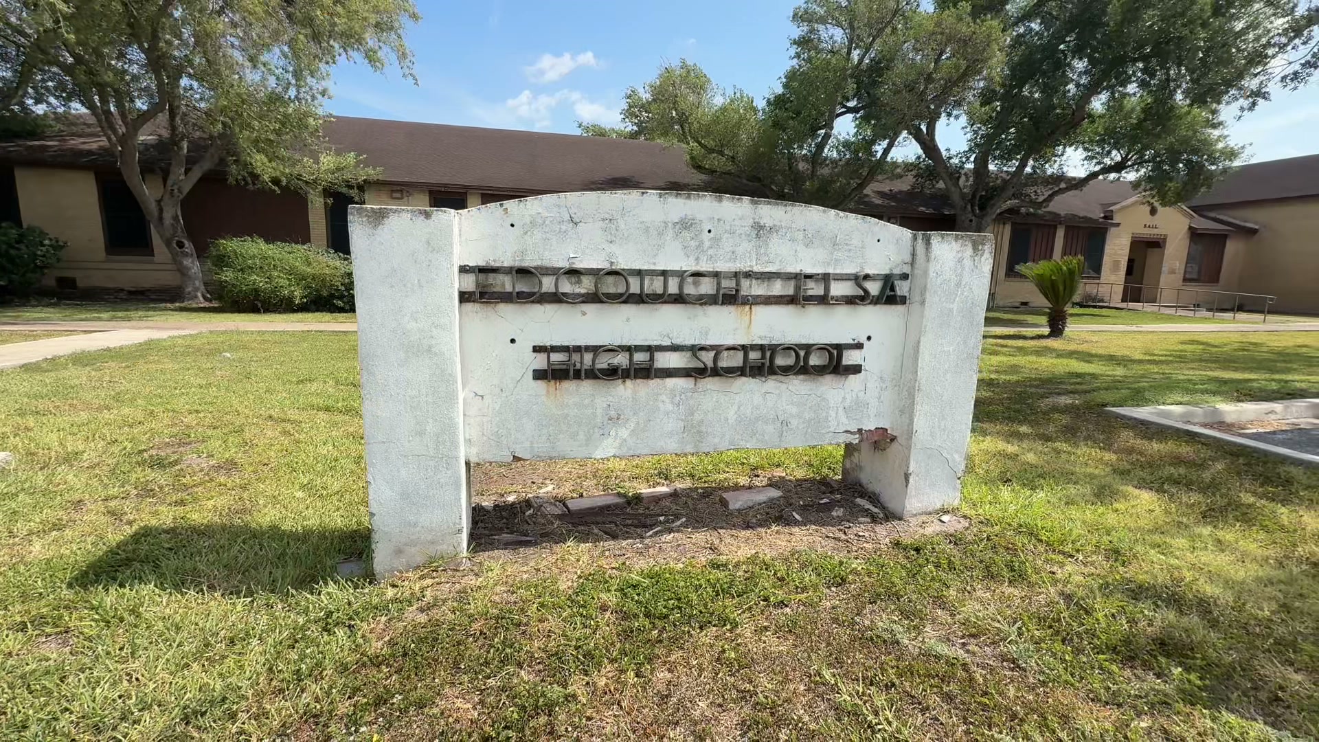 The weathered Edcouch-Elsa High School sign standing on the former campus